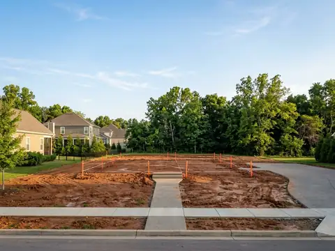 A new home rising from a cleared lot to framing to a finished house