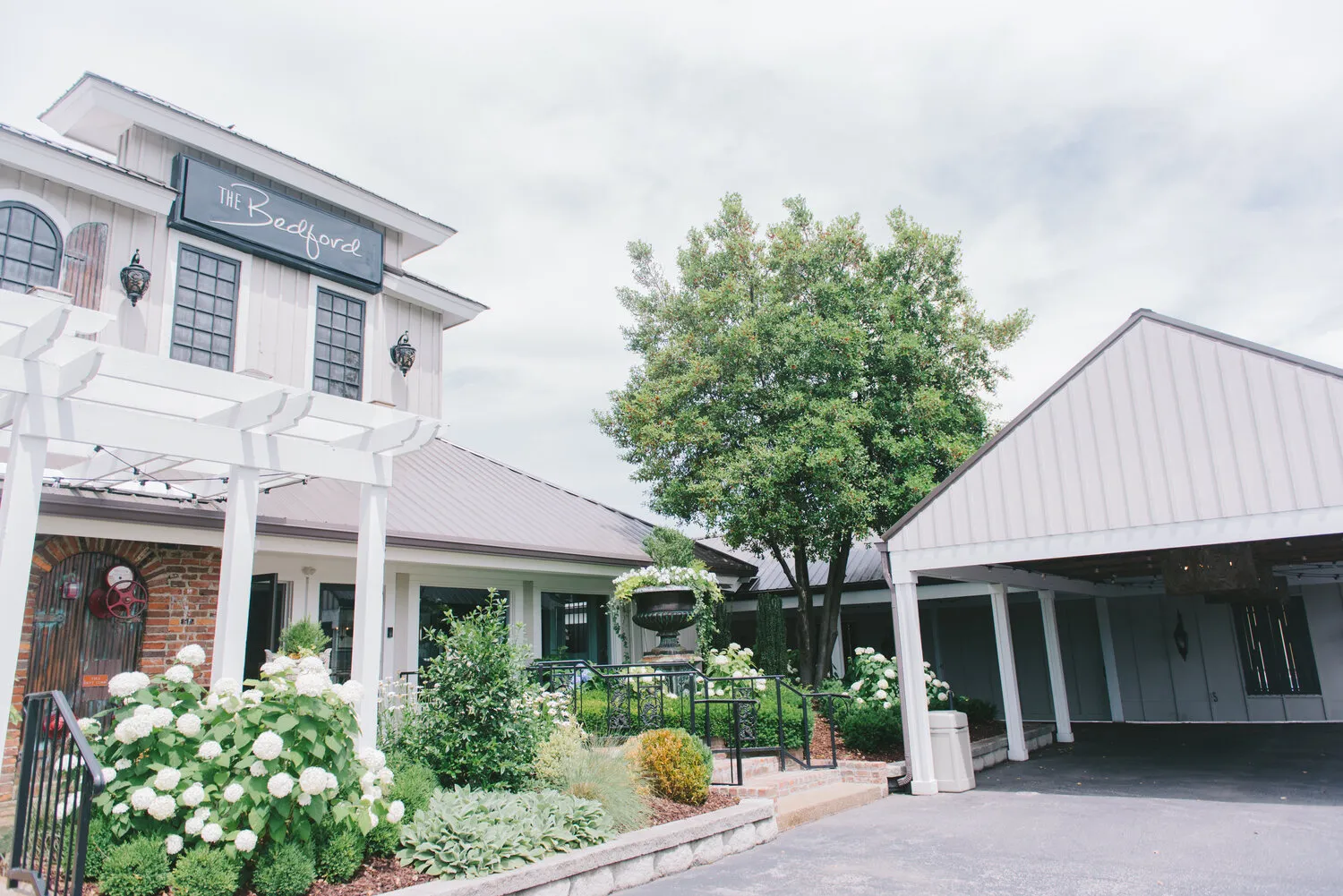 exterior of a commercial building with flowers in front