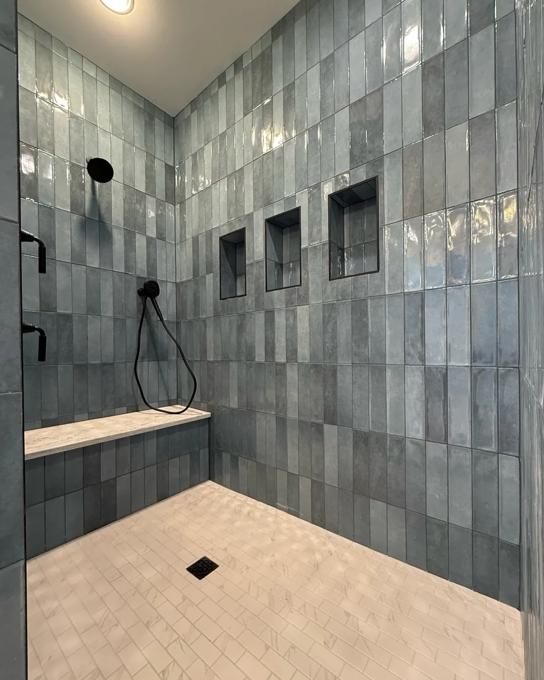 Large walk in shower with a bench